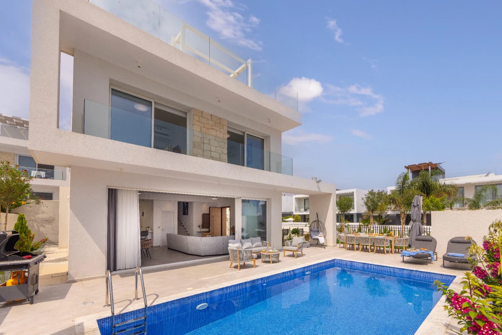 The villa facade seen across the pool.