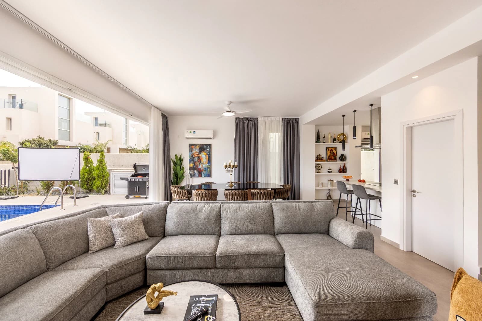 The full width of the living room and its sectional sofa.